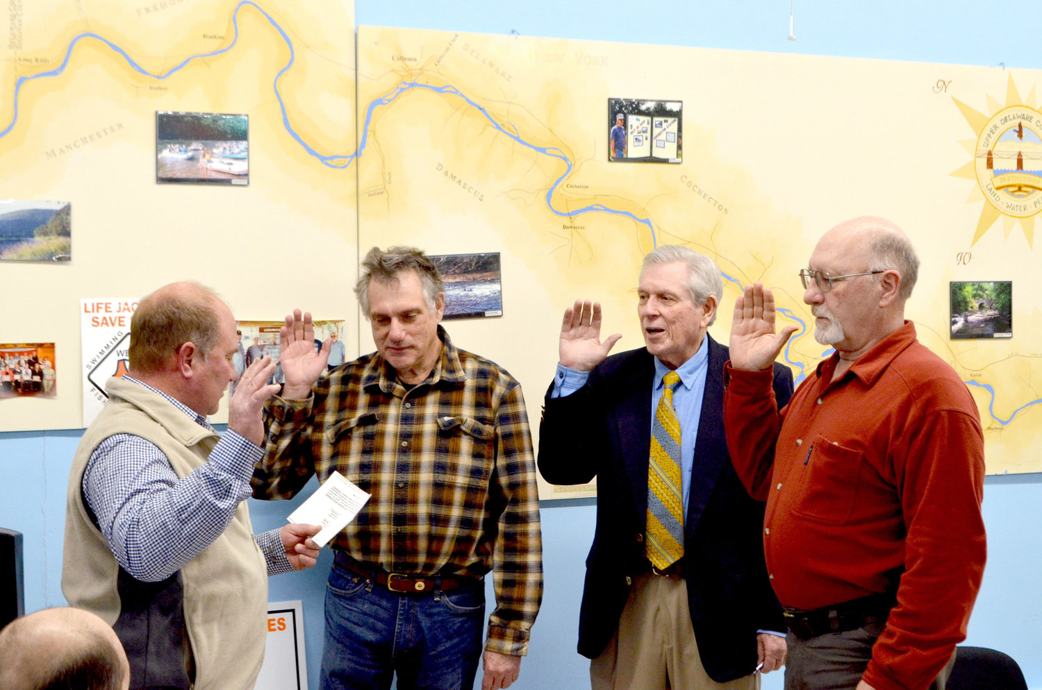 Town of Highland supervisor Jeff Haas, left, administers oaths of office to Upper Delaware Council vice-chairperson Aaron Robinson, Chairperson Andrew Boyar and Secretary/Treasurer Alan Henry.